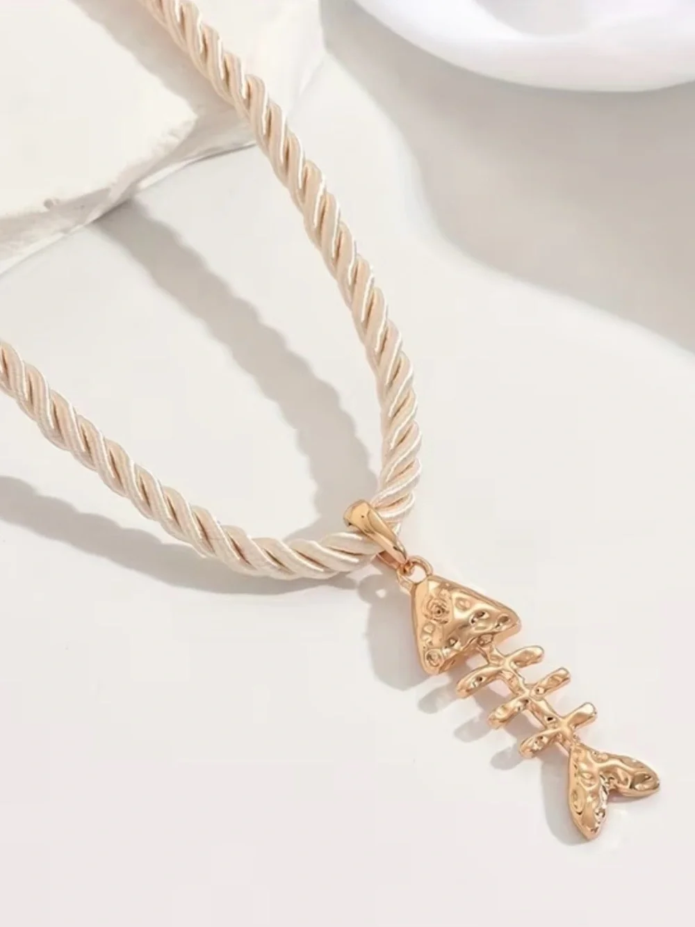 Gold Fishbone Pendant Necklace on Cream Rope Chain
